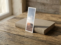 Lonely Mesa fine art bookmark resting on a linen-bound book in soft window light