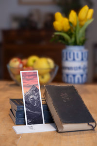 Lonely Mountain fine art bookmark styled with a dark book and fresh fruit