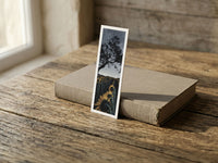 Midnight Sun fine art bookmark resting on a linen-bound book in soft window light