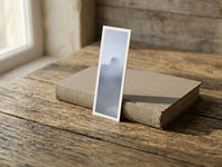 Misty Pagoda fine art bookmark resting on a linen-bound book in soft window light