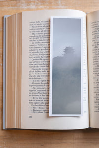 Misty Pagoda fine art bookmark resting in an open book, close-up
