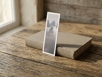 Misty Spires fine art bookmark resting on a linen-bound book in soft window light