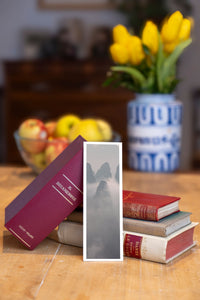 Misty Spires fine art bookmark beside a stack of vintage books