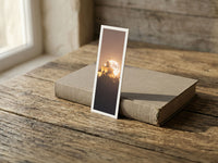 Moonlight Dance fine art bookmark resting on a linen-bound book in soft window light