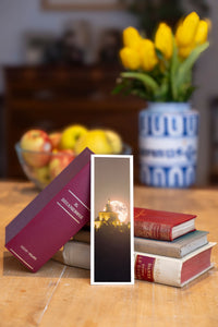 Moonlight Dance fine art bookmark beside a stack of vintage books