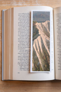 Painted Minerals fine art bookmark resting in an open book, close-up