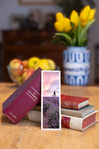 Purple Breeze fine art bookmark beside a stack of vintage books
