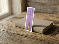 Purple Fields fine art bookmark resting on a linen-bound book in soft window light