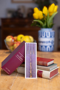 Purple Fields fine art bookmark beside a stack of vintage books