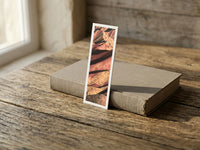 Rainbow Ridge fine art bookmark resting on a linen-bound book in soft window light