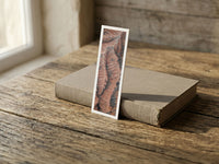 Scarlet Folds fine art bookmark resting on a linen-bound book in soft window light