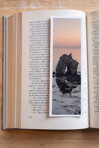 Sea Arch fine art bookmark resting in an open book, close-up