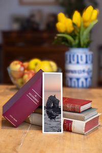 Sea Arch fine art bookmark beside a stack of vintage books