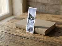 Sea Gate fine art bookmark resting on a linen-bound book in soft window light