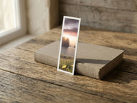 Sea Pillars fine art bookmark resting on a linen-bound book in soft window light