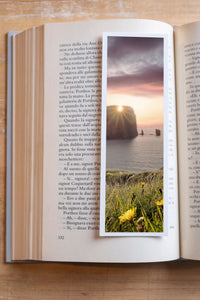 Sea Pillars fine art bookmark resting in an open book, close-up