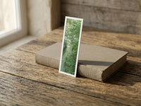 Secret Jungle fine art bookmark resting on a linen-bound book in soft window light