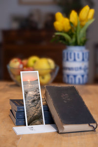 Shimmering Sunset fine art bookmark styled with a dark book and fresh fruit