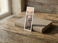 Shimmering Sunset fine art bookmark resting on a linen-bound book in soft window light