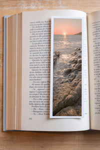 Shimmering Sunset fine art bookmark resting in an open book, close-up