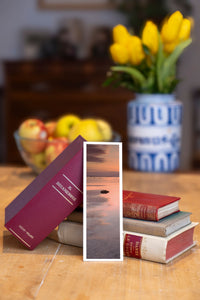 Silent Low Tide fine art bookmark beside a stack of vintage books