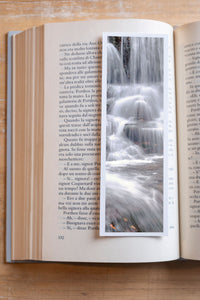 Silver Flowing fine art bookmark resting in an open book, close-up
