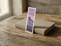 Snowy Dawn fine art bookmark resting on a linen-bound book in soft window light
