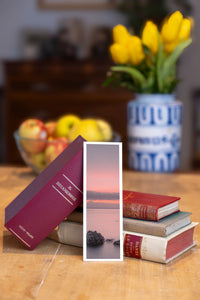 Soft Evening fine art bookmark beside a stack of vintage books