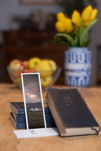 Starry Camp fine art bookmark styled with a dark book and fresh fruit
