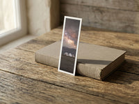 Starry Camp fine art bookmark resting on a linen-bound book in soft window light