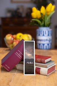 Starry Camp fine art bookmark beside a stack of vintage books