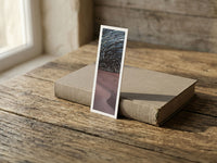 Starry Dunes fine art bookmark resting on a linen-bound book in soft window light