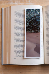 Starry Dunes fine art bookmark resting in an open book, close-up