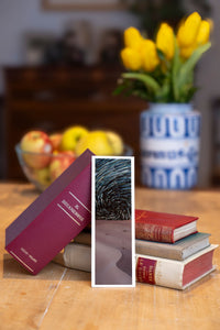 Starry Dunes fine art bookmark beside a stack of vintage books