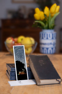 Starry Tree fine art bookmark styled with a dark book and fresh fruit