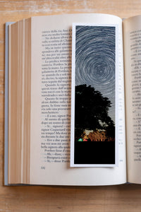 Starry Tree fine art bookmark resting in an open book, close-up