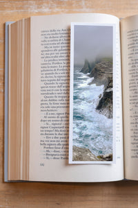Stormy Cliffs fine art bookmark resting in an open book, close-up