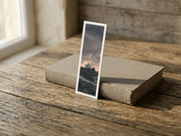Stormy Sanctuary fine art bookmark resting on a linen-bound book in soft window light