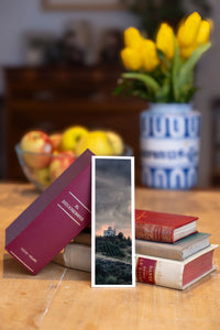 Stormy Sanctuary fine art bookmark beside a stack of vintage books