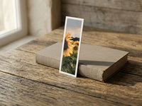 Summer Sunflowers fine art bookmark resting on a linen-bound book in soft window light