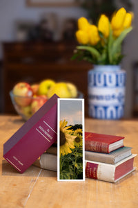 Summer Sunflowers fine art bookmark beside a stack of vintage books