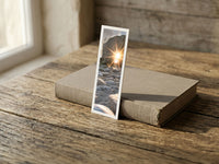 Sunburst fine art bookmark resting on a linen-bound book in soft window light