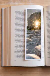 Sunburst fine art bookmark resting in an open book, close-up