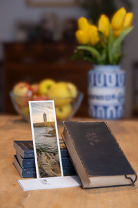Sunset Beacon fine art bookmark styled with a dark book and fresh fruit