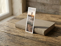 Sunset Beacon fine art bookmark resting on a linen-bound book in soft window light