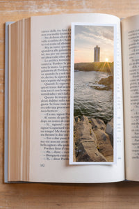 Sunset Beacon fine art bookmark resting in an open book, close-up