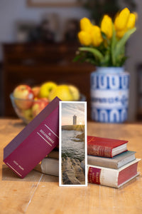 Sunset Beacon fine art bookmark beside a stack of vintage books