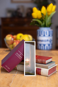Sunset Curtain fine art bookmark beside a stack of vintage books