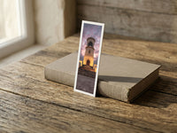 Sur Lighthouse fine art bookmark resting on a linen-bound book in soft window light