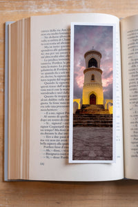Sur Lighthouse fine art bookmark resting in an open book, close-up